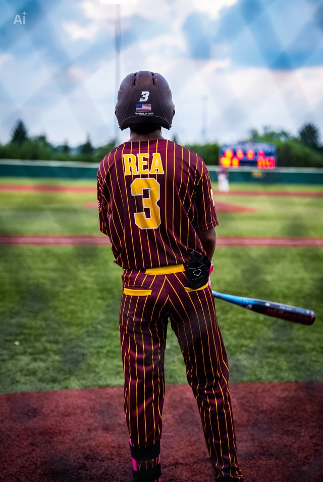 Baseball player number 3 standing at the edge of the field